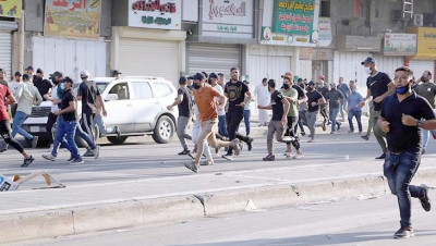 اشتباكات دامية بين قوى الأمن وأنصار ميليشيات إيران في بغداد